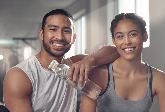 Fitness, portrait and water bottle with couple in gym together for bonding, training or workout. Break, exercise or smile with man and woman athlete in health club for challenge or performance - Powered by Adobe