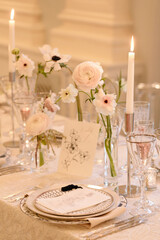 Elegant dining table setup featuring floral arrangements and candlelight for a special event in a lavish venue