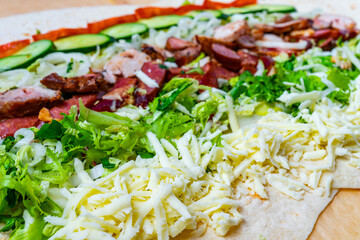 Freshly prepared wrap filled with vegetables and meat