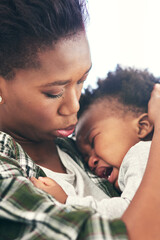 Crying, mother and comfort baby with hug for attention, security and support for child development....