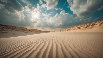Naklejka premium Aerial, elevated perspective of sandy landscape beneath a bright sky with clouds