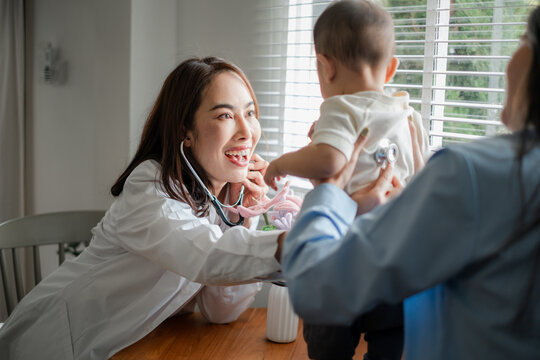 Pediatrician using stethoscope to examine baby in a bright room, showcasing a caring healthcare professional.