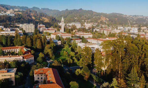 Aerial view of UC Berkeley campus, featuring students relaxing in the grassy area, and surrounding buildings. Beautiful sunny day.  Berkeley, California, USA