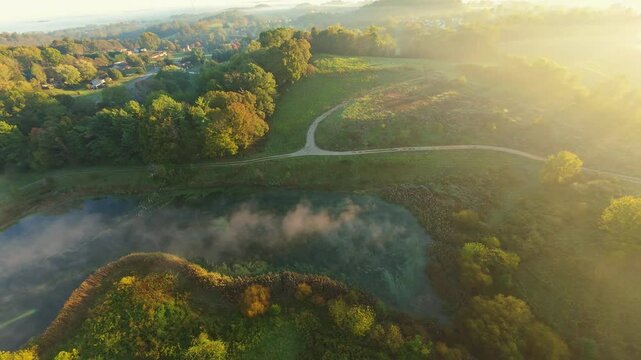 Aerial Drone View of Misty Pond and Trails Johnson City, TN scenic drone view of misty pond, winding trails lush greenery at sunrise Johnson City, Tennessee golden sunlight peaceful serene atmosphere