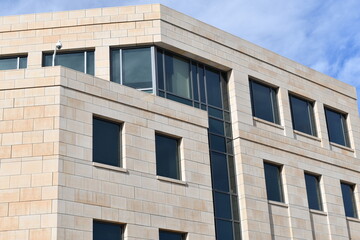 Modern government building, stone construction, security cameras.