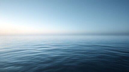 scene of calm sea water with a faint mist hovering just above the surface, blending into the horizon 
