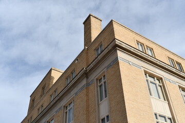 Large brick building, tan in color.