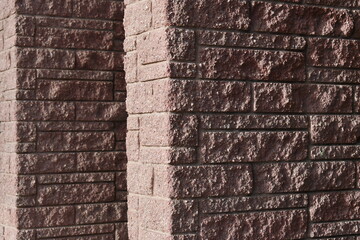 Red brick wall corner in alleyway.