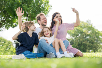 Fototapeta premium Happy family parent children having picnic outdoor activity. Enjoy happiness moment summer playing together including father mother son and daughter relaxing in the morning sunrise.