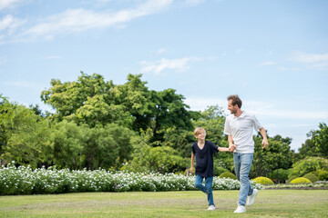Happy family parent children having picnic outdoor activity. Enjoy happiness moment summer playing together including father mother son and daughter relaxing in the morning sunrise.