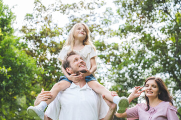 Fototapeta premium Happy family parent children having picnic outdoor activity. Enjoy happiness moment summer playing together including father mother son and daughter relaxing in the morning sunrise.