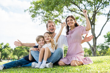 Fototapeta premium Happy family parent children having picnic outdoor activity. Enjoy happiness moment summer playing together including father mother son and daughter relaxing in the morning sunrise.