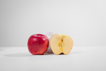 A supplement bottle and a fresh apple placed on the table, symbolizing health and nutrition, representing dietary choices, wellness, and natural or medical supplementation for a balanced lifestyle