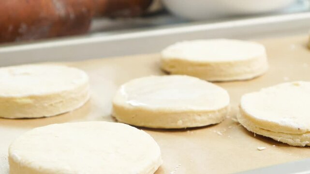 Baking some honey buttermilk biscuits for breakfast.  Using flour, honey, butter, buttermilk and cream for freshly baked biscuits.  Baking breakfast biscuits that are homemade for cozy mornings.