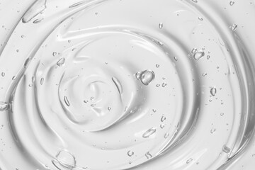 Gel serum texture.  Clear cosmetic cream background. Liquid skincare product with bubbles closeup