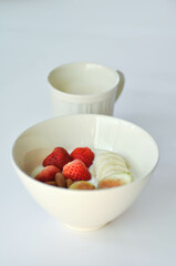 yogurt with fruit topping or strawberry, almond with fig and banana in natural yogurt and milk
