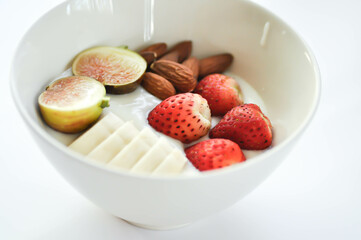 yogurt with fruit topping or strawberry, almond with fig and banana in natural yogurt