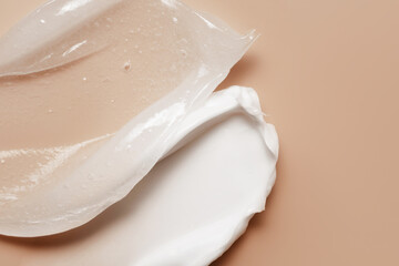 Cosmetic cream and vaseline swatches. Slugging skincare routine. Moisturizer and petroleum jelly ointment smeared on beige background