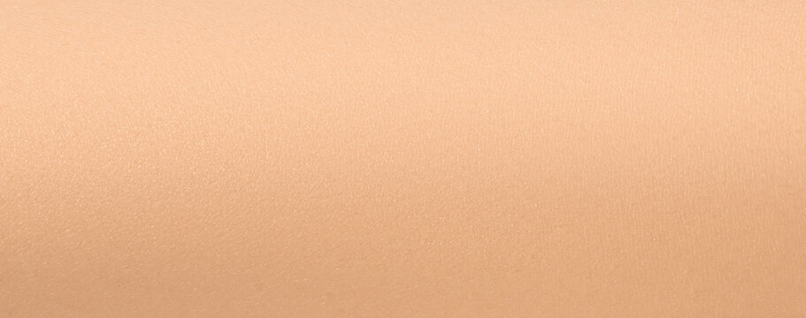 Human skin texture background. White female arm skin close up