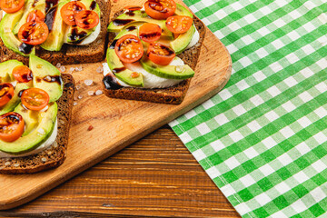 Delicious open-faced sandwiches featuring fresh ingredients on wooden board