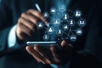 Digital B2B technology concept with icons and businessman holding mobile device and stylus on a blurred background.