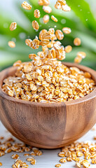 Obraz premium Rolled oats falling into wooden bowl, healthy breakfast