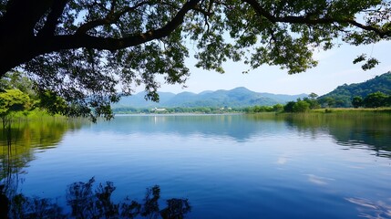 Fototapeta premium Serene Lake View Surrounded by Lush Greenery and Majestic Mountains Under a Clear Blue Sky : Generative AI