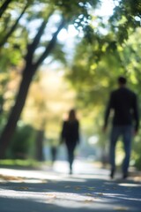 Obraz premium Aesthetic blurred image of two people walking down a tree lined pathway in autumn colors : Generative AI