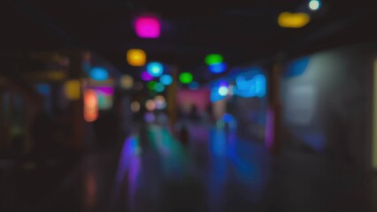 Blurred colorful lights create a festive atmosphere in a dark hall