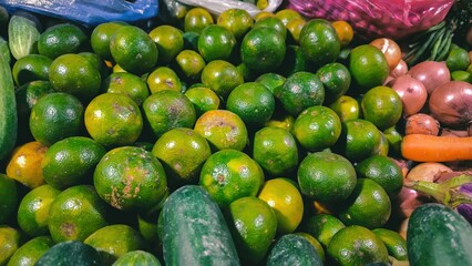 Vibrant display of fresh citrus fruits and vegetables at local market