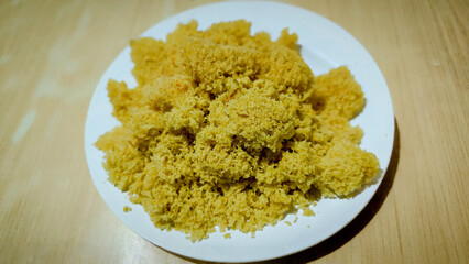 Crispy fried kremesan served on a white plate offering a delicious Indonesian culinary experience in a simple setting