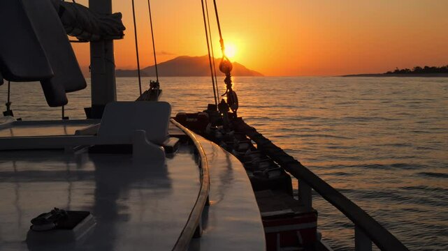 View from a sailboat of a beautiful sunset in the Indian Ocean. Slow motion. Golden hour. 4k Resolution Video