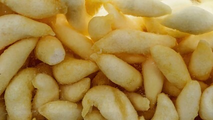 Close-up of savory cork egg cheese sticks. These golden-yellow snacks boast a crispy and crunchy texture