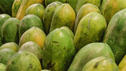Close-up View of Freshly Harvested Papayas Displayed in Abundance at Market