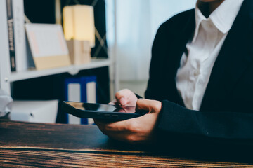 Business Professional Using Smartphone in Modern Office Setting, business concept