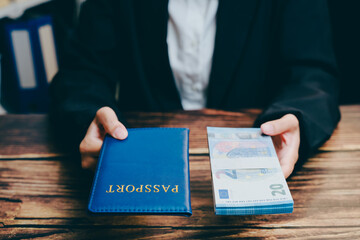 Person Holding Passport and Banknotes on Wooden Table Background, business concept