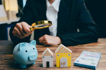 Financial Review of Real Estate Investment with Magnifying Glass, business concept