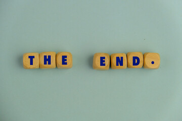Text the end written on a wooden cube