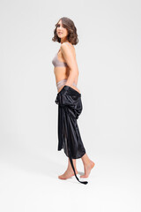 Sexy attractive young brunette posing in trendy lingerie in the studio.