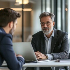 Obraz premium Professional Business Meeting: Senior Executive Discussing Strategy with Young Colleague at Modern Office 