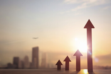 Soaring arrow symbolizing business success and growth with financial city background, stock and...