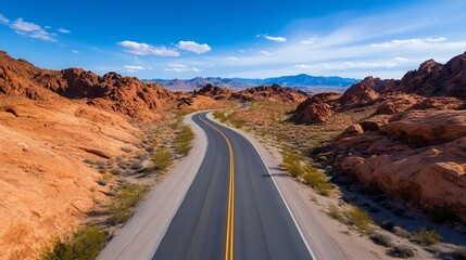 Fototapeta premium Scenic Winding Road Through Majestic Red Rock Landscape Under Blue Sky with Fluffy White Clouds : Generative AI