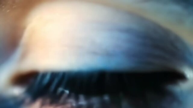 Close-up of a human eye showcasing intricate details of the iris and eyelashes against a blurred background