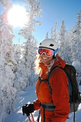 Female athlete is ski touring in snowy forest during winter, enjoying backcountry skiing, vertical
