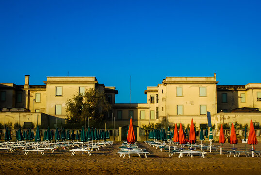 Gli ombrelloni colorati e le sedie a sdraio di uno stabilimento balneare pronte per una giornata di mare sulla spiaggia di Pesaro