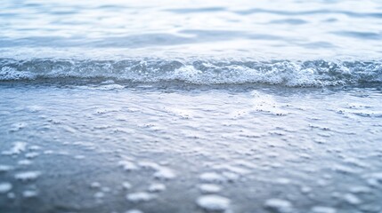 Obraz premium Close-up view of gentle ocean waves lapping against a sandy beach under soft light : Generative AI
