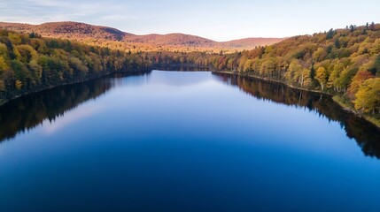 Obraz premium Serene Lake Surrounded by Vibrant Autumn Foliage and Blue Sky : Generative AI