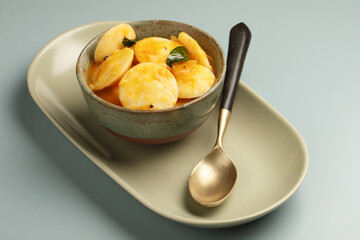 Idli Sambar, South Indian Dish served in ceramic bowl
