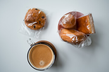 Assorted pastries and coffee on white background