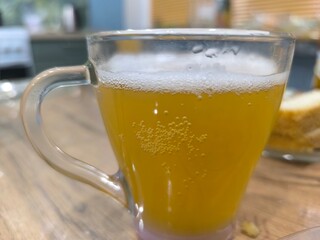 Full pint glass of beer sitting on bar counter